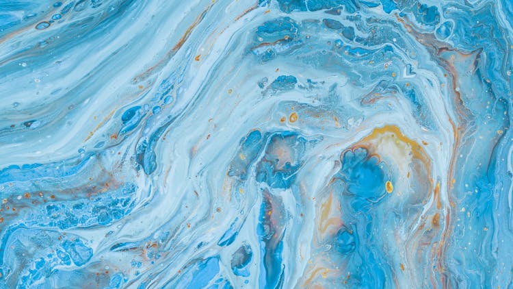 Abstract image of blue chemicals mixing