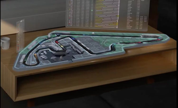Demonstration of Apple Vision Pro's F1 app concept, showcasing a 3D map of a racetrack on a coffee table.