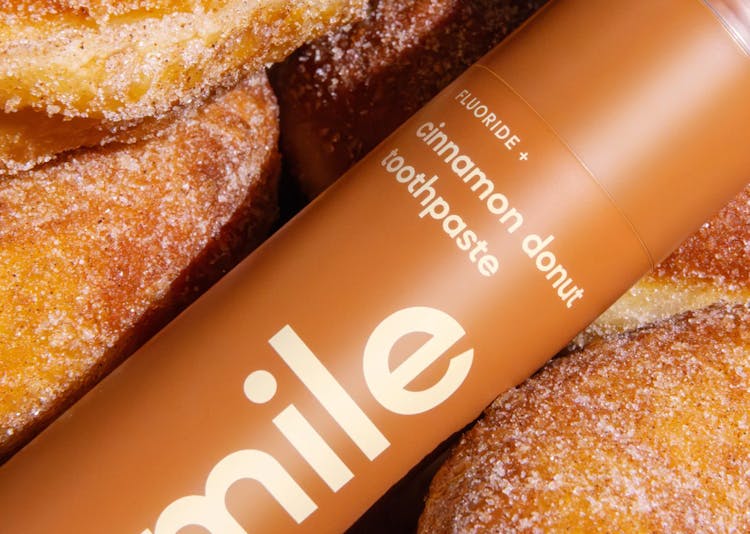 Promotional image of HiSmile Cinnamon Donut Toothpaste tube and donuts.