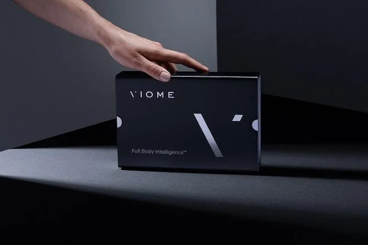 Viome box with a hand touching it